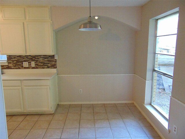 unfurnished dining area featuring light tile patterned flooring and a healthy amount of sunlight