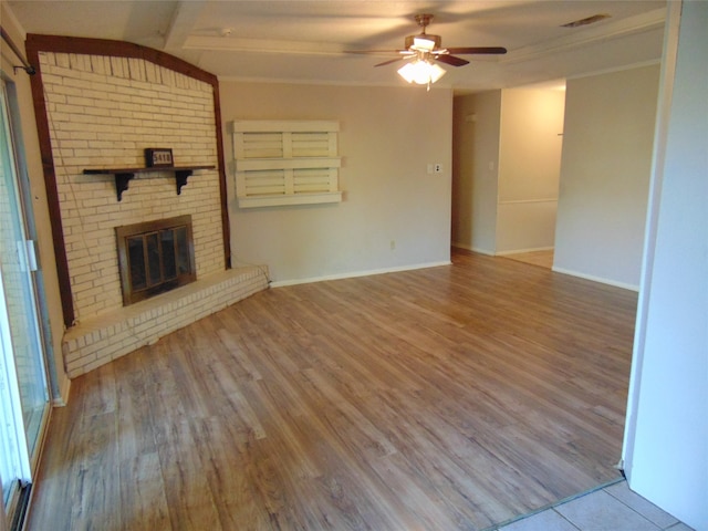 unfurnished living room with hardwood / wood-style floors, ceiling fan, vaulted ceiling with beams, and a fireplace