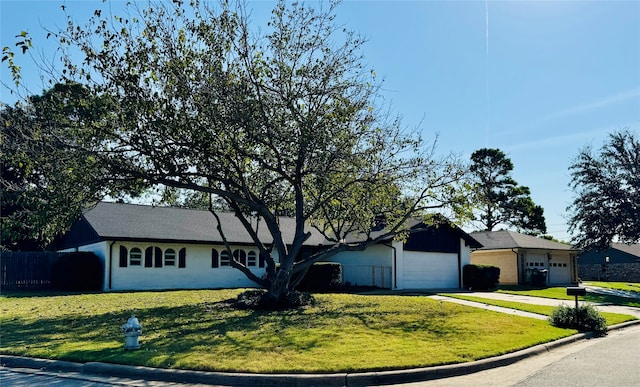 ranch-style home featuring a front yard and a garage