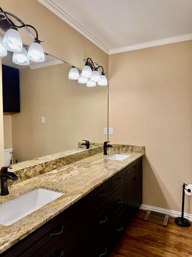 bathroom with hardwood / wood-style flooring, ornamental molding, toilet, and vanity