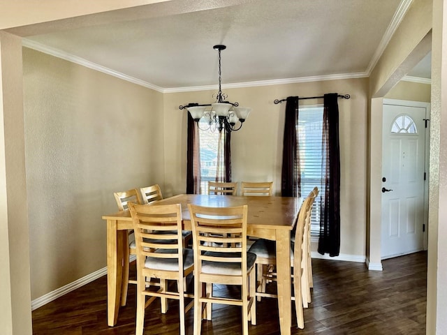 dining area featuring crown molding, dark hardwood / wood-style flooring, and an inviting chandelier