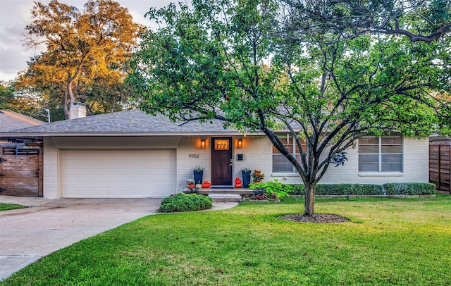 view of front of property with a garage and a front yard