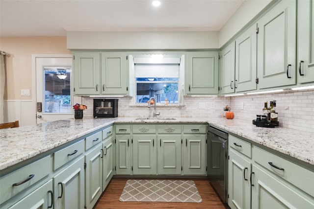 kitchen featuring dishwasher, dark hardwood / wood-style flooring, light stone counters, and sink