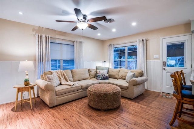 living room featuring ceiling fan and hardwood / wood-style flooring