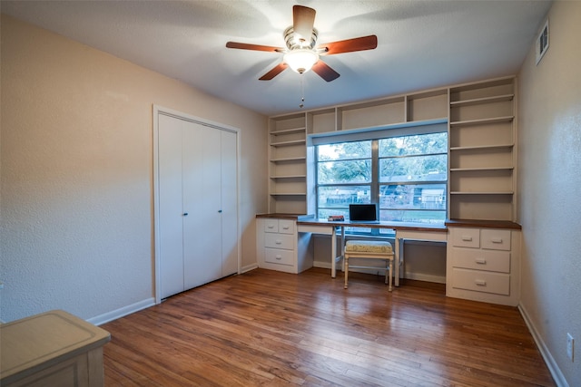 unfurnished office featuring ceiling fan and dark wood-type flooring