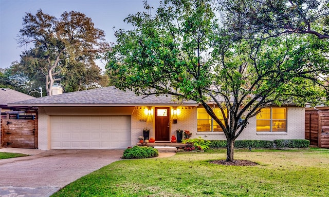 ranch-style home with a garage and a front yard