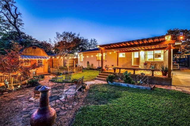 yard at dusk with a pergola and a patio