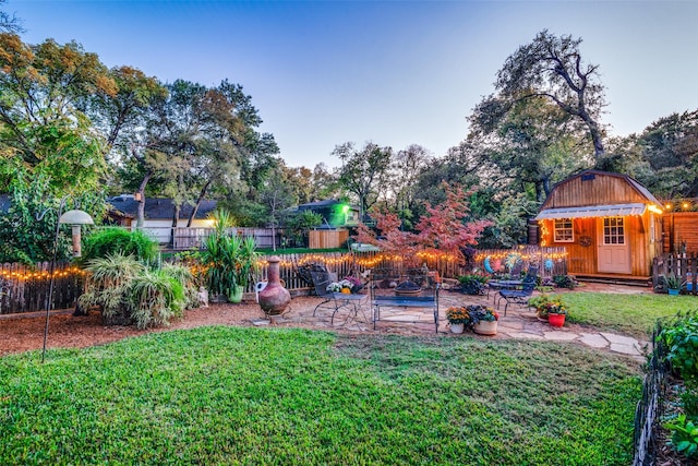 view of yard featuring a patio and an outdoor structure