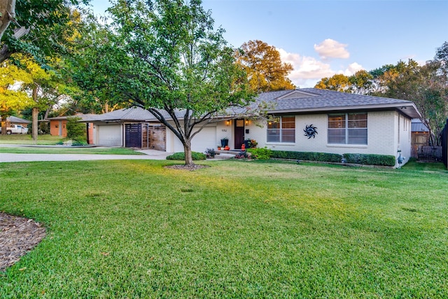 single story home with a front yard and a garage