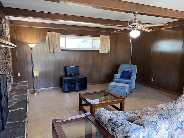 living room featuring ceiling fan, beamed ceiling, and wooden walls