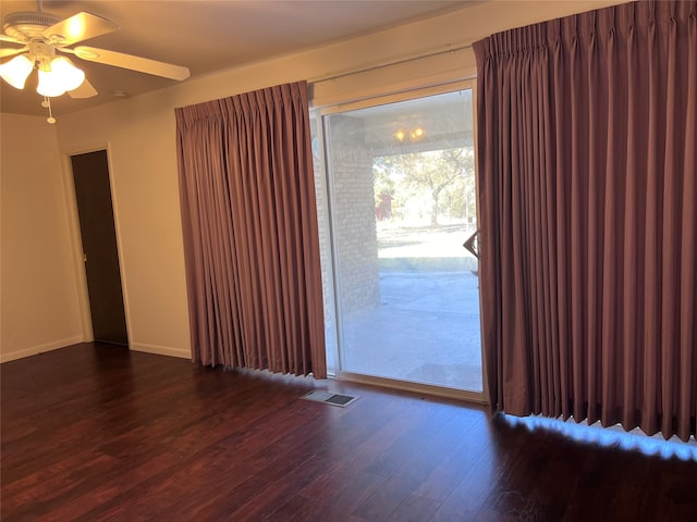 spare room featuring dark hardwood / wood-style flooring and ceiling fan