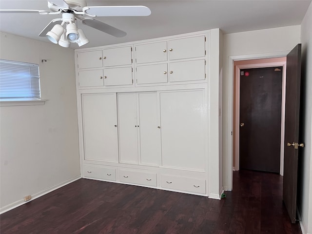 unfurnished bedroom with ceiling fan, a closet, and dark hardwood / wood-style flooring