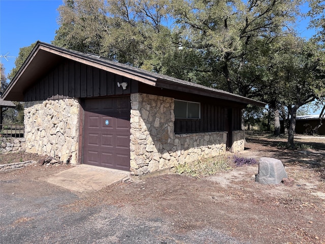 view of home's exterior featuring a garage and an outbuilding