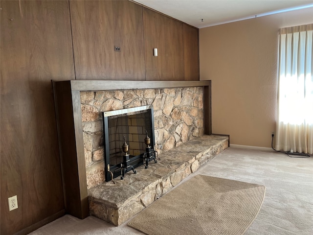 details featuring a stone fireplace and carpet floors