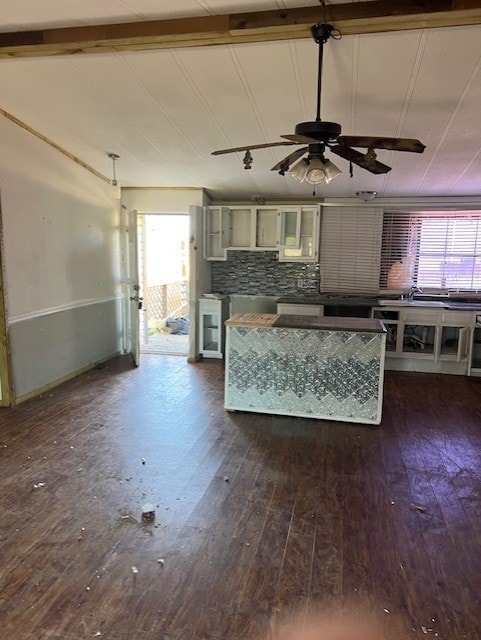 kitchen with backsplash, ceiling fan, lofted ceiling with beams, and dark hardwood / wood-style floors