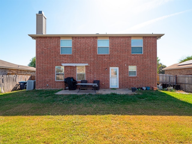 back of property with a patio, central AC, and a yard