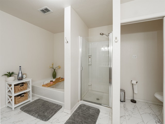 bathroom with toilet and shower with separate bathtub