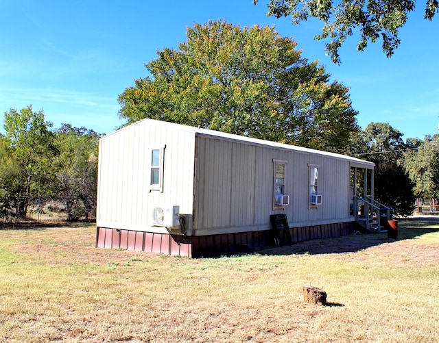 exterior space featuring cooling unit and a yard