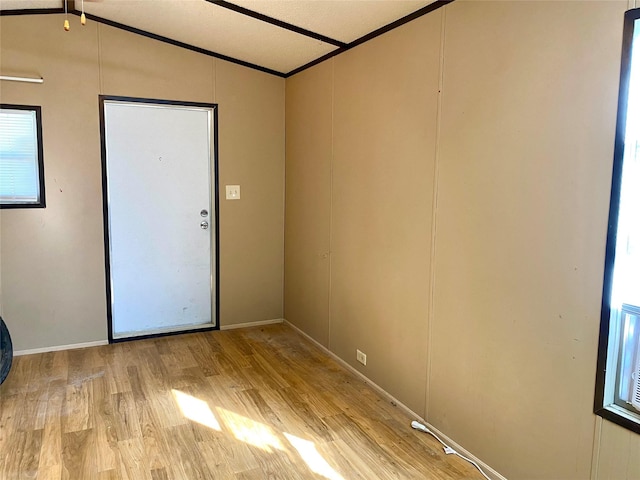 unfurnished room featuring ornamental molding and light hardwood / wood-style floors