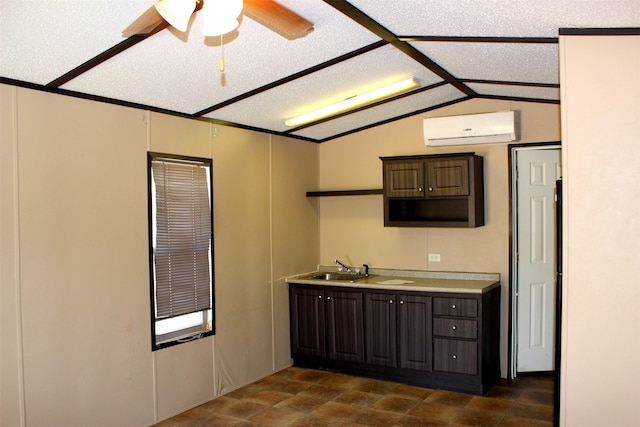 kitchen featuring an AC wall unit, lofted ceiling, dark brown cabinetry, and a textured ceiling