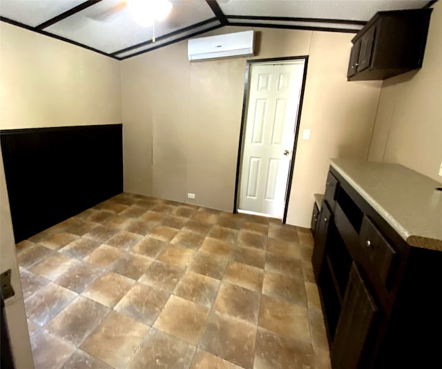 basement featuring ceiling fan and a wall unit AC