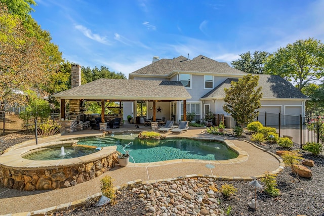 view of pool featuring an outdoor living space, an in ground hot tub, pool water feature, and a patio area