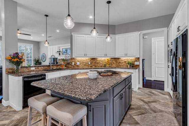 4604 Wisdom Creek Ct, Flower Mound, TX 75022 - kitchen with decorative backsplash, a sink, white cabinets, black appliances, and recessed lighting