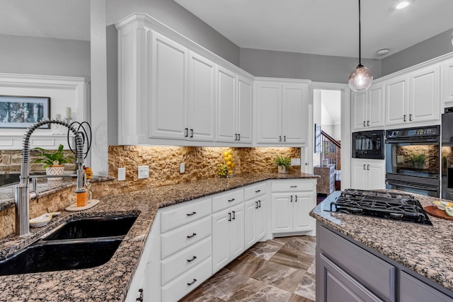 4604 Wisdom Creek Ct, Flower Mound, TX 75022 - kitchen with white cabinets, a sink, dark stone countertops, backsplash, and black appliances