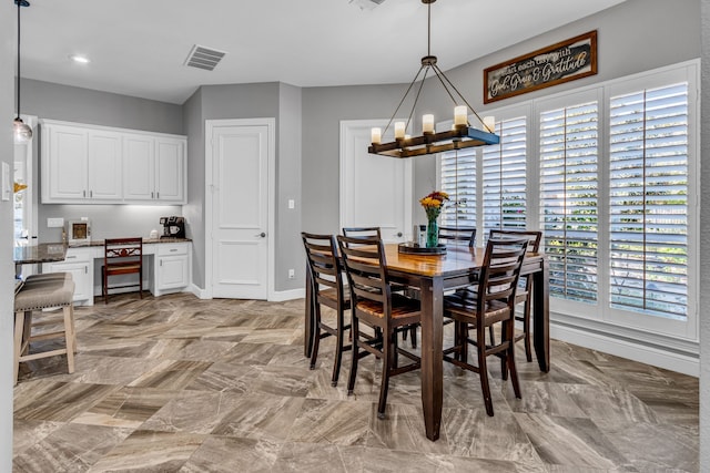 dining space featuring a chandelier and a healthy amount of sunlight