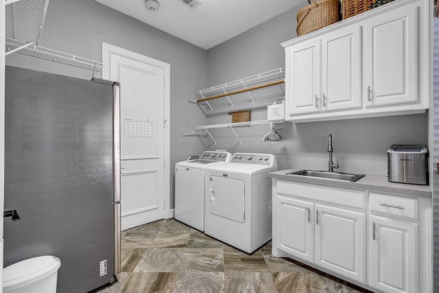 4604 Wisdom Creek Ct, Flower Mound, TX 75022 - laundry area with visible vents, washing machine and clothes dryer, cabinet space, a sink, and marble finish floor