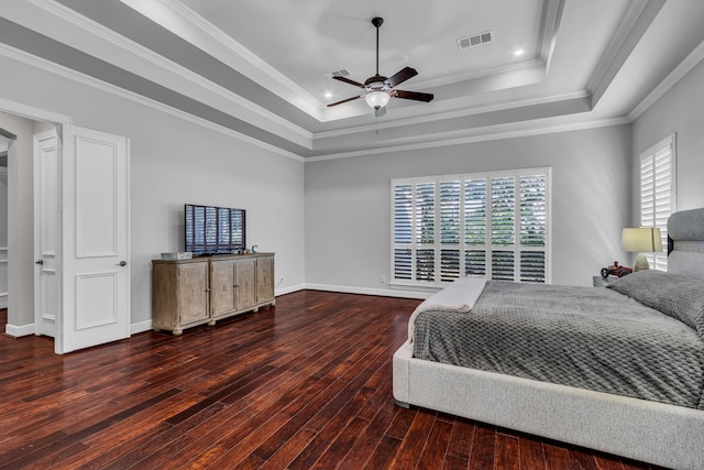 bedroom featuring ceiling fan, ornamental molding, a tray ceiling, and dark hardwood / wood-style floors