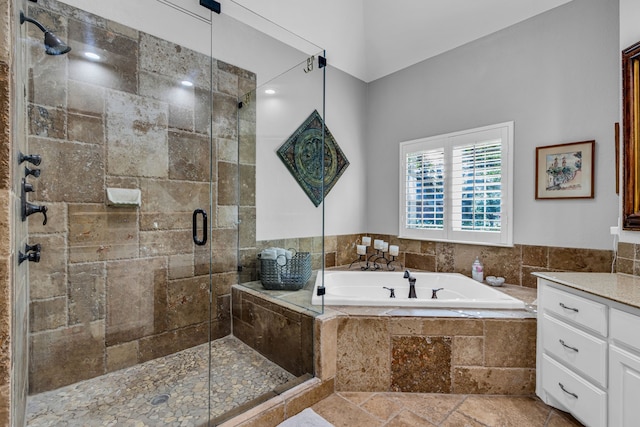 bathroom with vanity and separate shower and tub