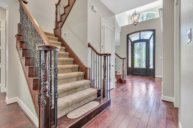 4604 Wisdom Creek Ct, Flower Mound, TX 75022 - entrance foyer with an inviting chandelier, wood-type flooring, stairs, baseboards, and visible vents