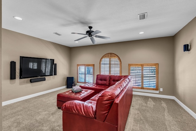 living room featuring light carpet, a textured ceiling, and ceiling fan