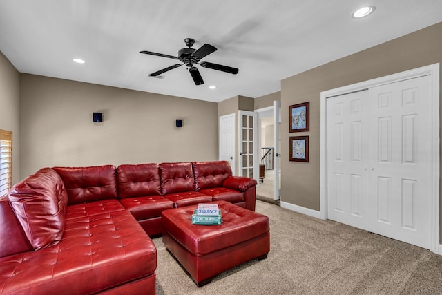 carpeted living room with ceiling fan