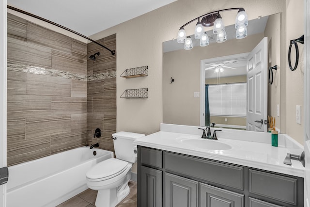 full bathroom featuring toilet, tile patterned flooring, tiled shower / bath, vanity, and ceiling fan