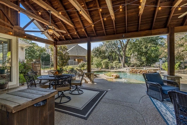 view of patio / terrace featuring a fenced in pool and ceiling fan