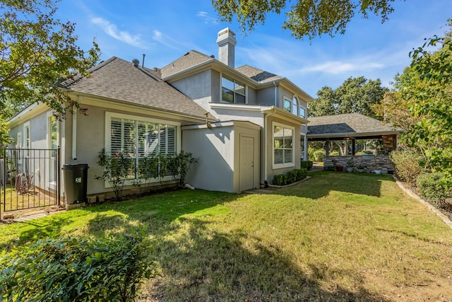 back of house with a lawn