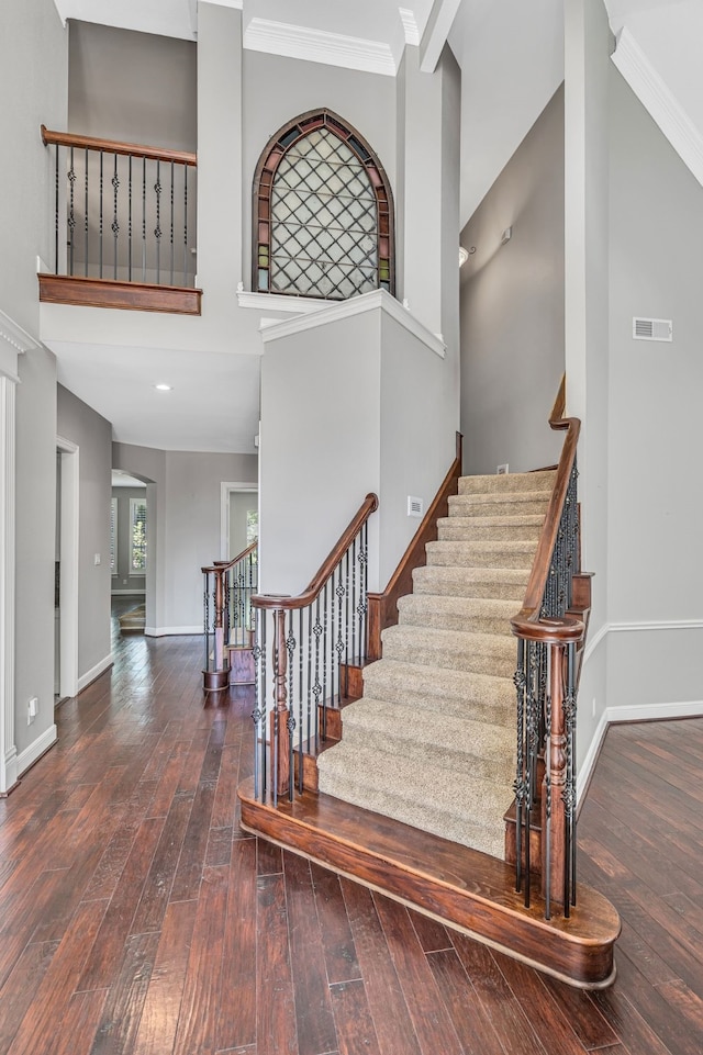 4604 Wisdom Creek Ct, Flower Mound, TX 75022 - stairway featuring visible vents, crown molding, baseboards, wood-type flooring, and a high ceiling