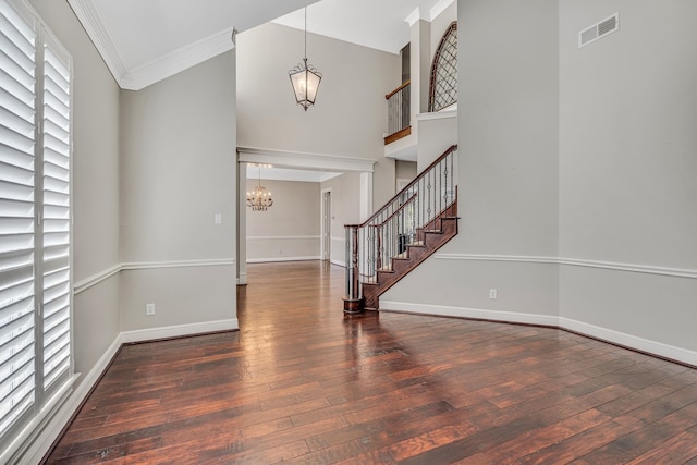 4604 Wisdom Creek Ct, Flower Mound, TX 75022 - foyer entrance featuring wood-type flooring, an inviting chandelier, ornamental molding, and visible vents
