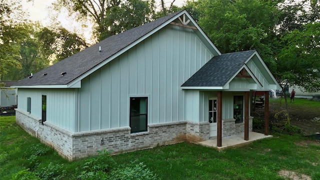 1212 Albertson, Tyler, TX 75702 - rear view of property with a shingled roof, board and batten siding, and a yard