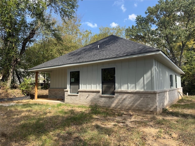 1212 Albertson, Tyler, TX 75702 - back of property with a shingled roof, board and batten siding, and brick siding