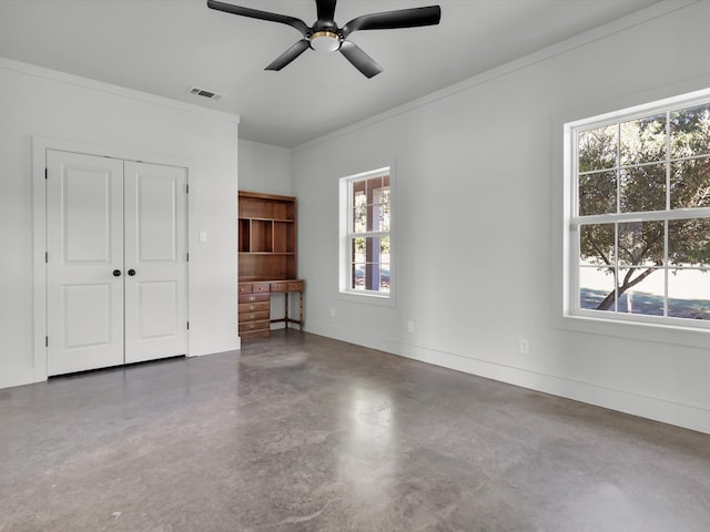 unfurnished bedroom featuring ceiling fan, a closet, concrete flooring, and ornamental molding