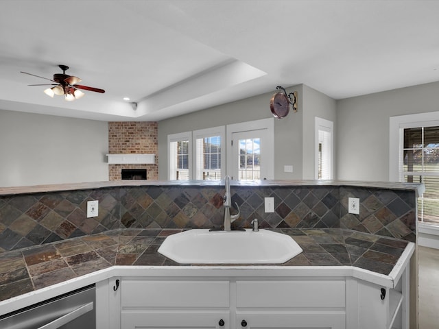 kitchen featuring plenty of natural light, white cabinetry, and backsplash