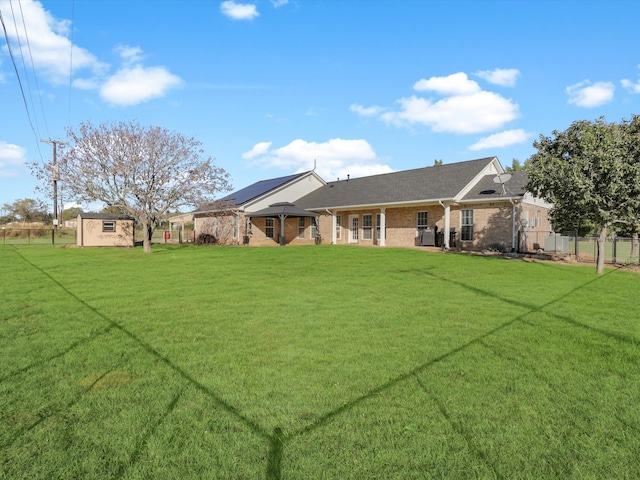 exterior space with a storage shed and a lawn