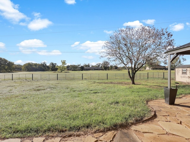 view of yard with a rural view