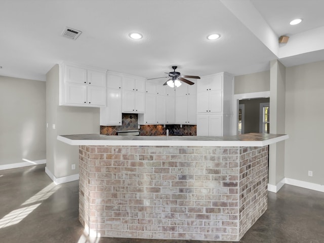 kitchen featuring tasteful backsplash, white cabinetry, and ceiling fan