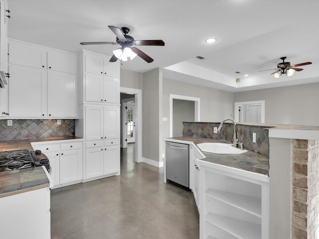 kitchen featuring backsplash, stainless steel dishwasher, sink, white cabinets, and range