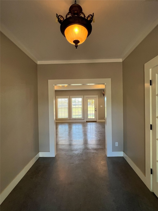 empty room featuring crown molding