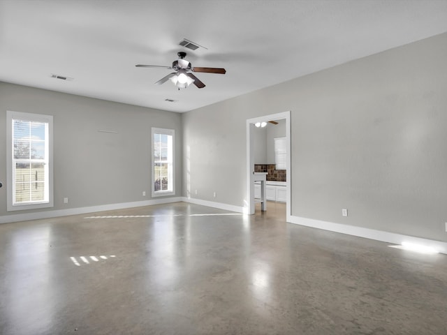 spare room with concrete flooring and ceiling fan